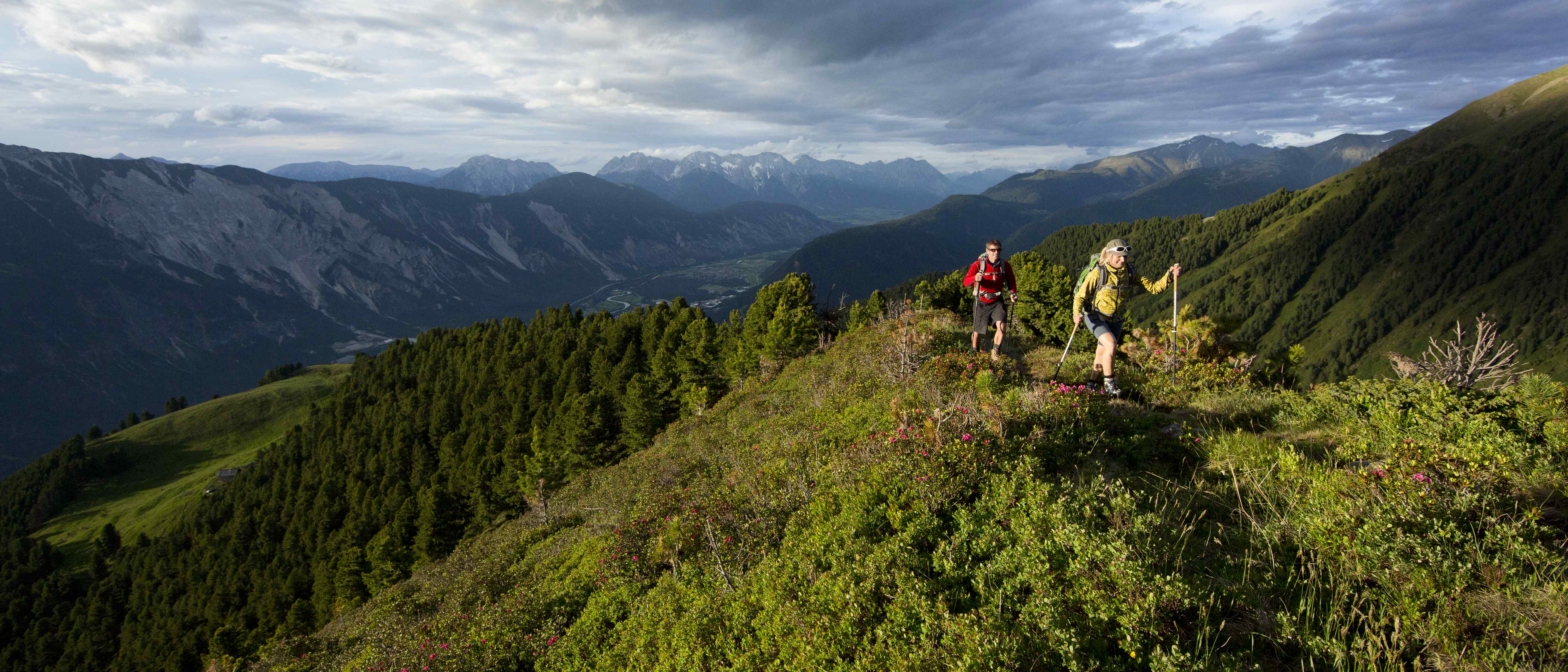 Man and Woman Walking infront of Mountains