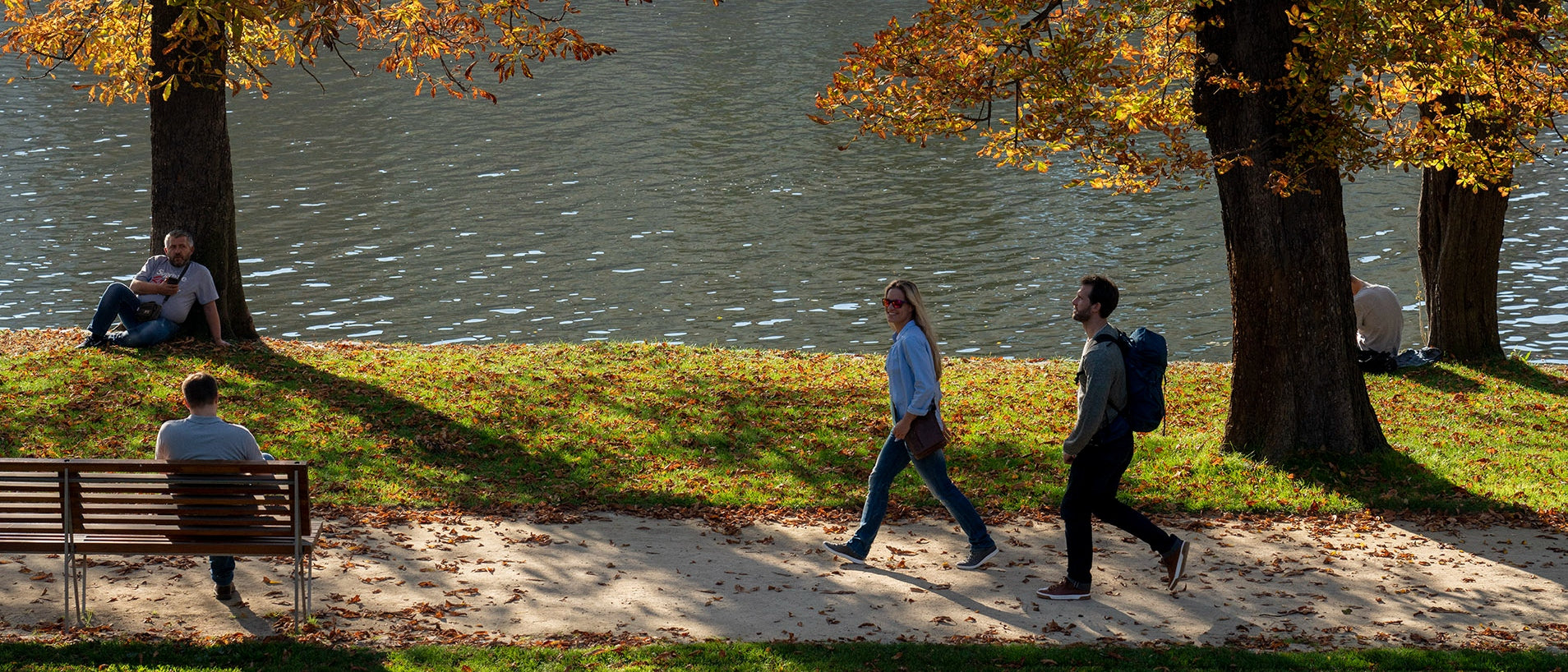 People Walking by Urban River