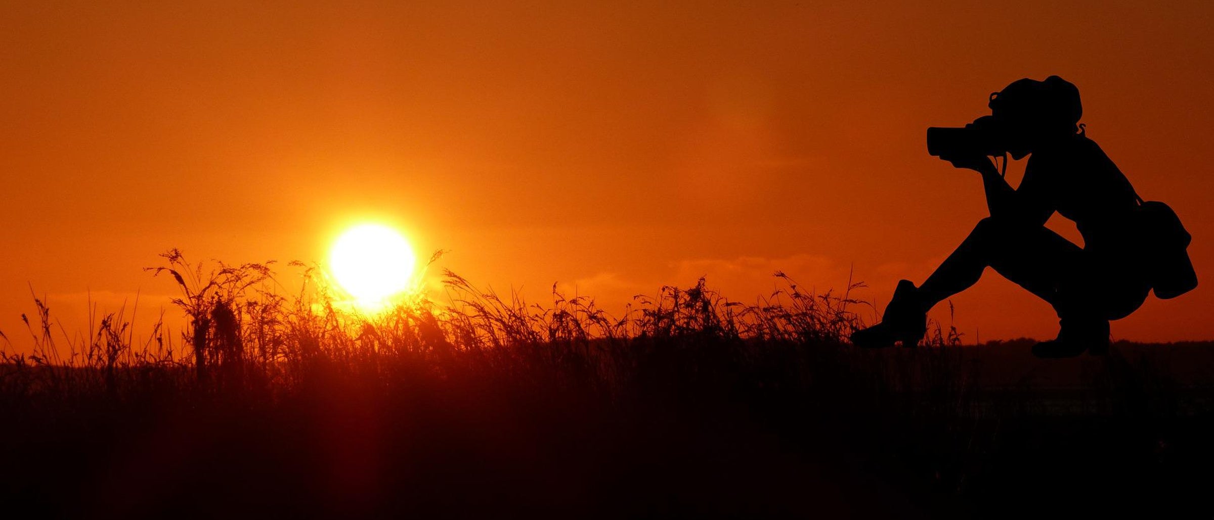 Photographer Sillohuetted infront of Sunset